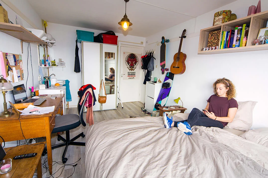 Cluttered bedroom photo before AI cleanup